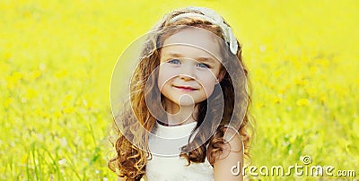 Portrait little girl child in spring field with dandelions flowers Stock Photo