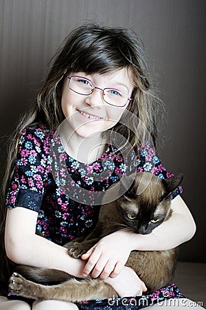 Portrait of little girl holding burmese cat Stock Photo