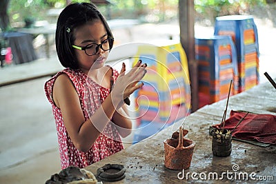 Portrait little girl molds the clay for producing the pottery work in workshop class Stock Photo