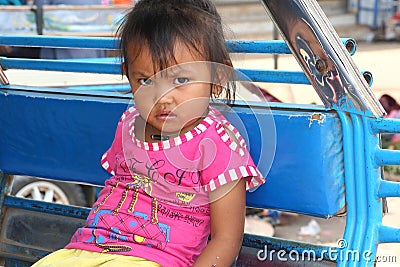 Portrait of an Asian little girl in a tuk tuk, Laos Editorial Stock Photo