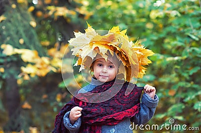 Portrait of a little girl in a wreath of autumn leaves Stock Photo