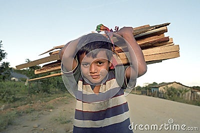 Portrait little Latino boy with firewood on neck Editorial Stock Photo