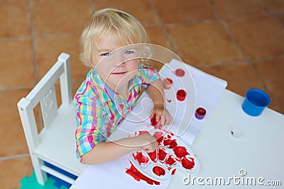 Portrait of little toddler girl painting with brush Stock Photo