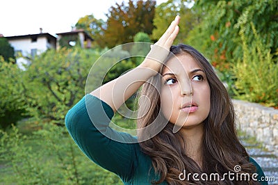 Portrait of lovely brunette woman remembered something and holds a hand Stock Photo