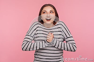 Portrait of lovely happy woman in striped sweatshirt dreaming and fantasizing, having pleasant memories Stock Photo