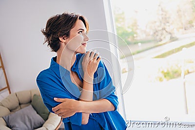 Portrait of lovely nice person hands touch shoulders look window fantasize imagine modern flat indoors Stock Photo