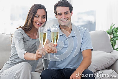 Portrait of lovers toasting their flutes of champagne Stock Photo