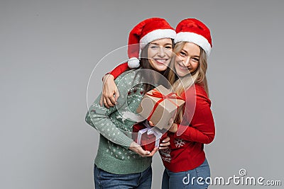 Best friends in Santa hats with Christmas presents. Stock Photo