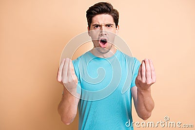 Portrait of mad annoyed guy claiming pretense having fight isolated over beige pastel color background Stock Photo