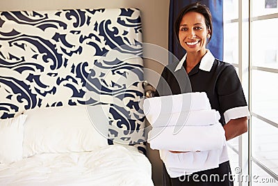 Portrait Of Maid Tidying Hotel Room Stock Photo