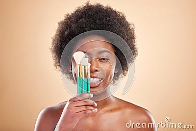 Portrait, makeup and a black woman with brushes on a studio background for wellness and foundation. Tongue out, beauty Stock Photo