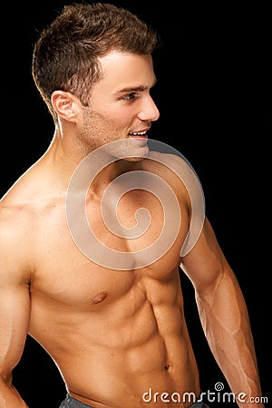 Portrait of a male athlete muscular on black Stock Photo