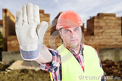 Portrait of male builder doing stop sign Stock Photo