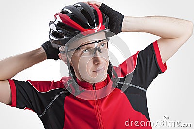 Portrait of Male Caucasian Cyclist Posing in Red Road Protective Helmet and Glasses. Stock Photo