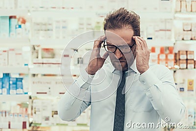 Portrait Male Customer having Headache in Pharmacy Stock Photo