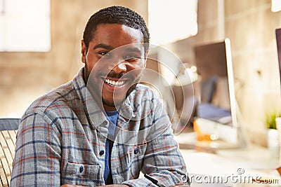 Portrait Of Male Designer Working At Desk In Modern Office Stock Photo