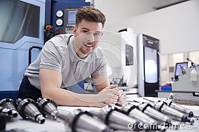 Portrait Of Male Engineer With CAD Drawings In Factory Stock Photo