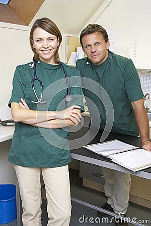 Portrait Of Male And Female Vets In Surgery Stock Photo