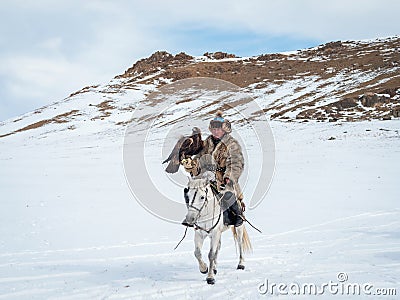 Portrait of a male hunter on horseback with a hunting golden eag Editorial Stock Photo