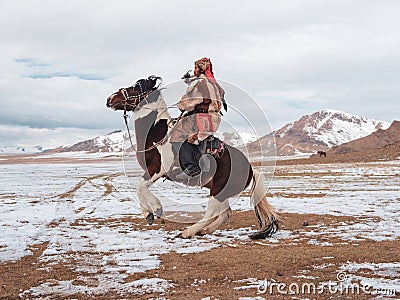 Portrait of a male hunter on horseback with a hunting golden eag Editorial Stock Photo