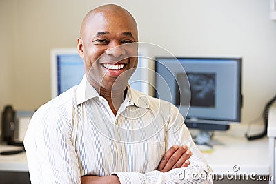 Portrait Of Male Obstetrician In Hospital Stock Photo