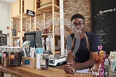 Portrait Of Male Owner Of Sustainable Plastic Free Grocery Store Behind Sales Desk Stock Photo