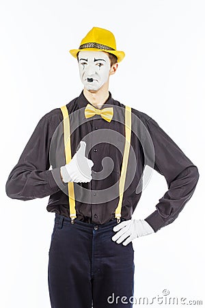 Portrait of a male, pantomime actor looking at camera and showing thumb up. Stock Photo