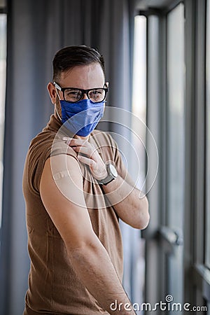 Portrait of male professional wearing mask got vaccinated against covid19 Stock Photo