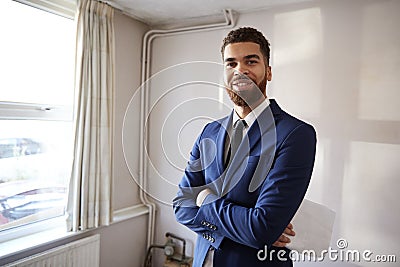 Portrait Of Male Realtor Looking At House Details In Property For Renovation Stock Photo