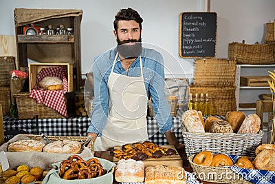 Portrait of male staff standing at bakery counter Stock Photo