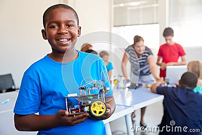 Portrait Of Male Student Building Robot Vehicle In After School Computer Coding Class Stock Photo