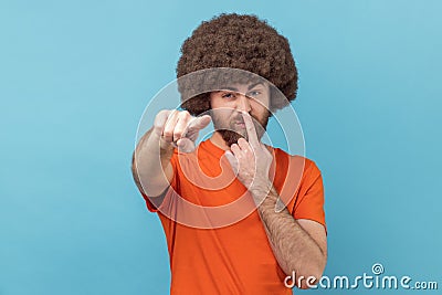Man touching nose, showing liar gesture, angry about falsehood, pointing to camera fake news. Stock Photo