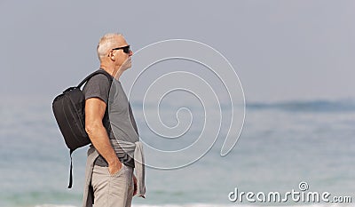 Portrait of a man with a backpack on the background of the sea Stock Photo