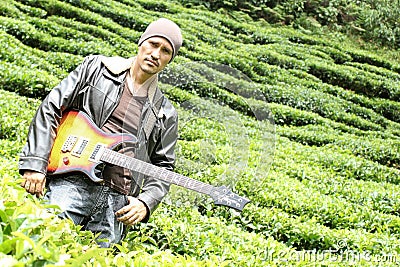 Portrait of a man with bass guitar in the nature Stock Photo