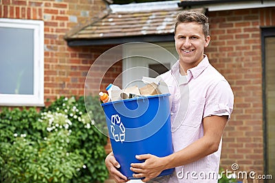 Portrait Of Man Carrying Recycling Bin Stock Photo