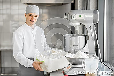 Confectioner working at the bakery manufacturing Stock Photo