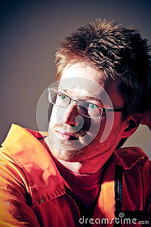 Portrait of a man in a dirty orange workwear Stock Photo