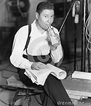 Portrait of man drinking bottle of milk Stock Photo