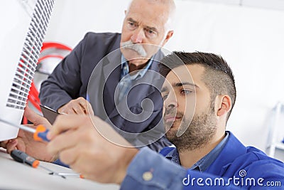 portrait man fixing electronic appliance Stock Photo