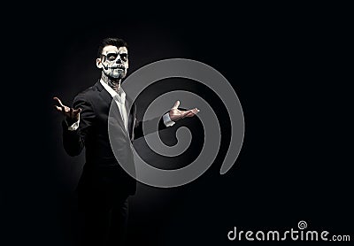 Portrait of man with Halloween skull makeup on the black backgro Stock Photo