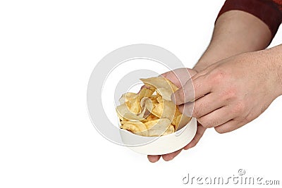 Portrait of man is holding in one hand potato chips in the bowl and other hand is picking chips Stock Photo