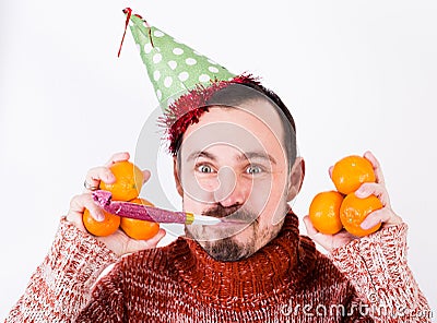 Portrait of Man on holiday in hat and whistle with tangerines Stock Photo