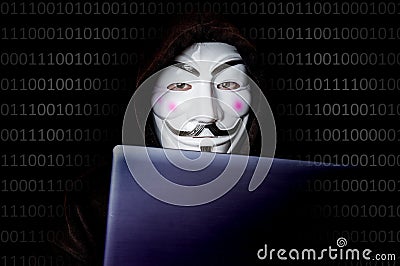 Portrait of man with laptop and vendetta mask isolated on black Editorial Stock Photo