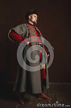 Portrait of a man in a medieval costume on a dark background. Clothes of the Polish gentry Stock Photo