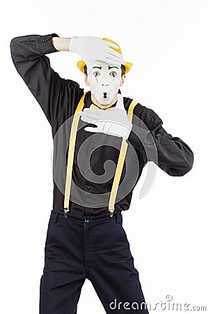 Portrait of a man, MIME, looking at camera and showing frame fin Stock Photo