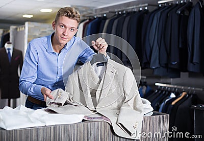 Portrait of man offering business style jacket Stock Photo