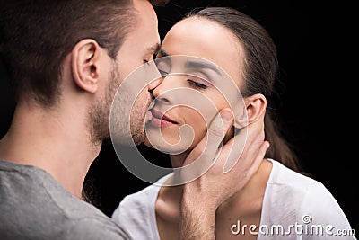 Portrait of man sensually kissing woman Stock Photo