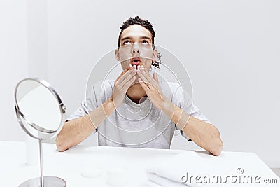 portrait of a man sit in front of the mirror, facial skin care skin health Stock Photo