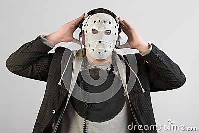 Portrait of a man in a suit and a creepy mask Stock Photo