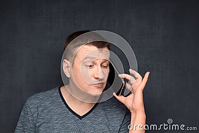 Portrait of man talking on phone with scornful expression Stock Photo